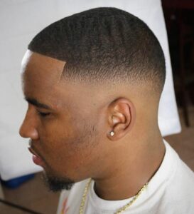 Afro hair buzz cut with waves and a fade